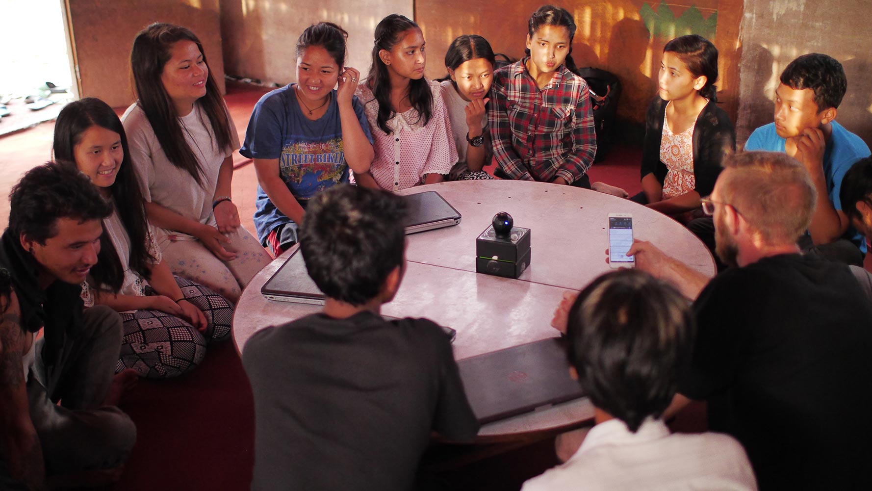 Group of children sitting on floor exploring technology